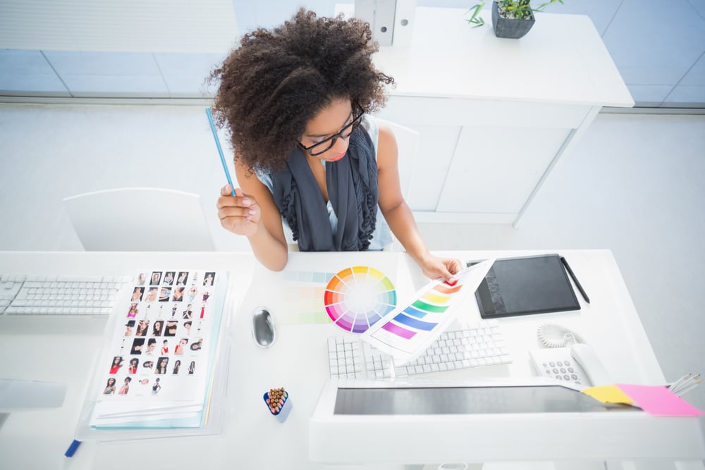 Pretty designer working at her desk in her office